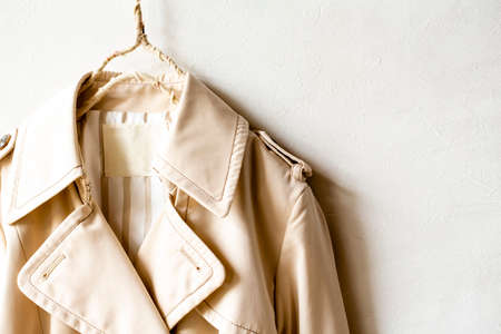 A beige trench coat isolated over white and close up.の写真素材