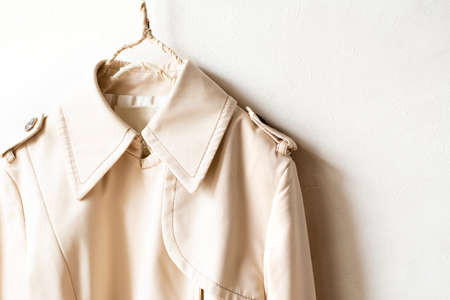A beige trench coat isolated over white and close up.の写真素材