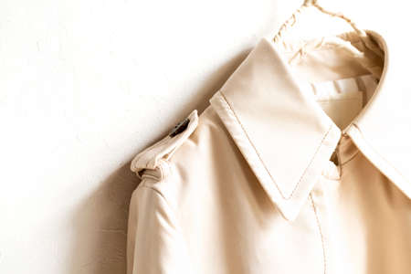 A beige trench coat isolated over white and close up.の写真素材