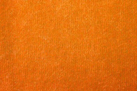 Background texture of orange pattern knitted fabric made of angora or wool. close up.の写真素材