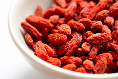 white bowl of red dried goji berries isolated on white background and copy space. close up.の写真素材