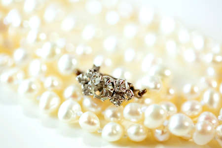 the clasp of pearl necklace on a white background and copy space. close up.の写真素材