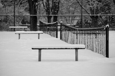 Empty tennis court covered with snow in the Stanley Park, Vancouver, Canadaの写真素材