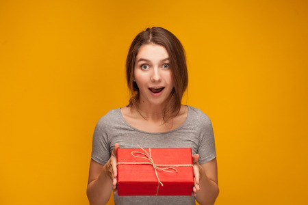 Pretty girl just recieved a gift. Or she want to give a giftの写真素材