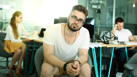 architect-designeres man and woman in the office are talking about new plan and project. Green tonning image. 16 in 9 film cropの写真素材