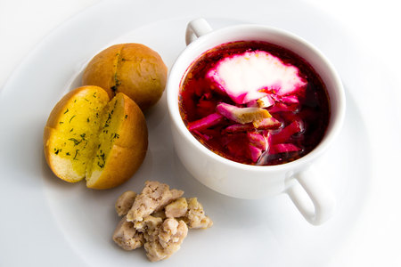 cold borsch with garlic bread and meat is plate isolated on white baackgroundの写真素材