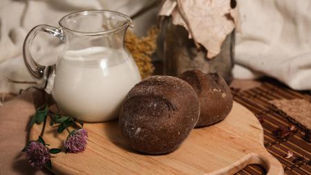 Milk and bread, Rye buns and clover on wooden desk. Food photo. Healthy Breakfast.の写真素材