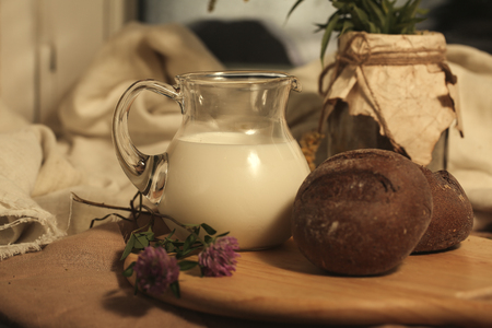 Milk and bread, Rye buns and clover on wooden desk. Food photo. Healthy Breakfast.の写真素材