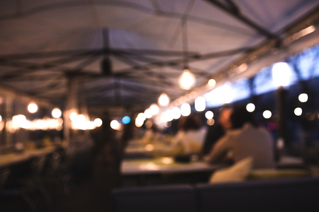 Blurred background made with Vintage Tones, Cafe blur background with bokeh. People woman and man at the table.の写真素材