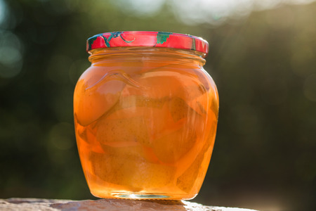 pear jam in jar and fresh pears on nature. Fresh sweet fruit delicacy. Agriculture concept. Food...