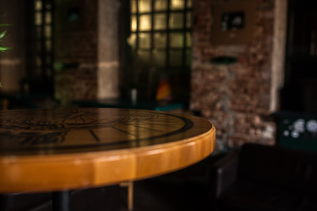 Wooden table in cafe on blurred Bokeh background as art design work for cutted isolated objects of food. Bar check in the morning. Lifestyle concept.の写真素材
