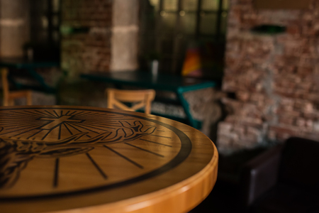 Wooden table in cafe on blurred Bokeh background as art design work for cutted isolated objects of food. Bar check in the morning. Lifestyle concept.の写真素材