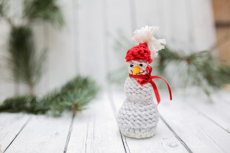 Christmas decoration in vintage toning on white wooden background with knitting snowman. Xmas decorative ornaments for design. Art work with texture for holiday new year 2017の写真素材