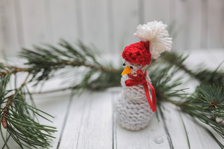Christmas decoration in vintage toning on white wooden background with knitting snowman. Xmas decorative ornaments for design. Art work with texture for holiday new year 2017の写真素材