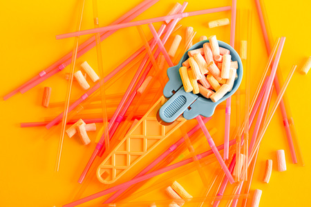 Multicolored Pastel background or colorful texture with top view. Pastel tasty fluffy sweet mini marshmallows. Minimal summer holiday style. Blue ice-cream Spoon and plastic cocktail ductsの写真素材