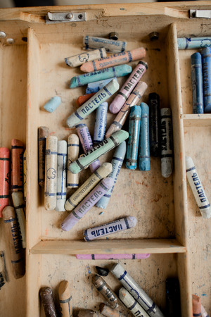 Wooden easel for the artist with pastel colors paints in white loft interior in scandinavian style.のeditorial素材