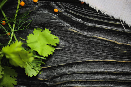 black wooden background. Blackboard. Grunge texture. Green and groats and white Linen cloth from above. Copy space for text and design. Top view wood for Foodの写真素材
