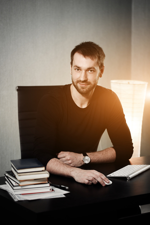 Smart businessman at workplace in office holding his head on hands. Sleepy worker early in the morning after late night work. Bisnanse and finance concept. Flare for Design and copy space.の写真素材