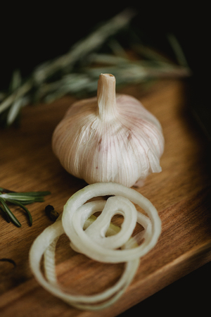 Healthy food with pranami spices and herbs, onion and garlic. Food photo for recipe or cookbook. Wooden black backround.の写真素材