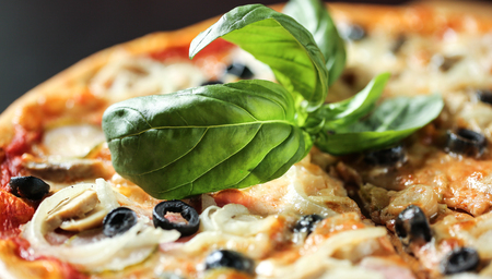 Healthy food. Close up food image of basil on italian pizza. Macro photography. Eating backgroundの写真素材