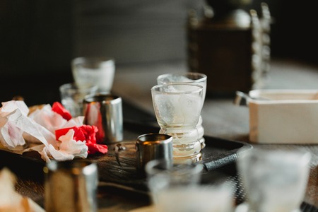 Dirty empty coffee cup, plate, dishes and remains of biscuits are on the table in cafe. Time after breakfast.の写真素材