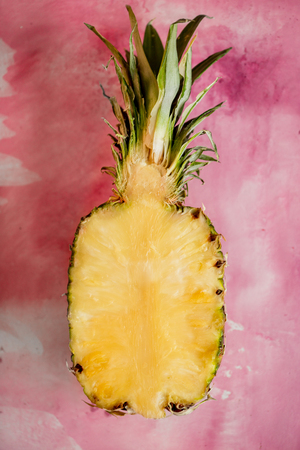 Cut sweet fashion Pineapple on a pink backgroundの写真素材