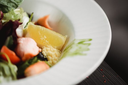 Close up food image of baked salmon salad. Macro food photography of healthy meal. Focus on lemon.の写真素材