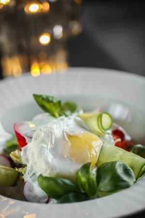 Fried Egg with vegetables on plate close up food photo.の写真素材