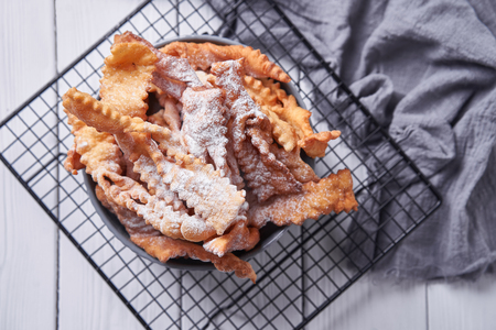 Brushwood - russian traditional cookies with powdered sugar. Food consept. Plate with hvorost on white marble background, Copyspace for text and design elements.の写真素材