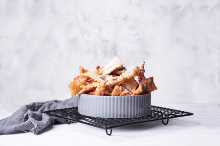 Brushwood - russian traditional cookies with powdered sugar. Food consept. Plate with hvorost on white marble background, Copyspace for text and design elements.の写真素材
