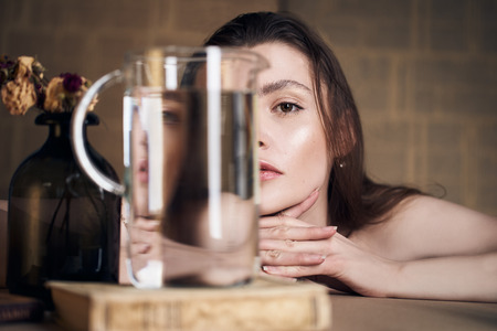 Beauty portrait of girl with water and reflections. Hight quality retouching photo. Fashion model.の写真素材