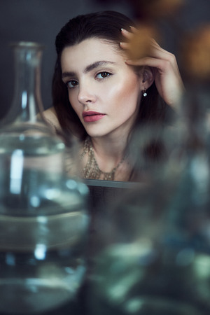 Beauty portrait of girl with water and reflections. Hight quality retouching photo. Fashion model.の写真素材