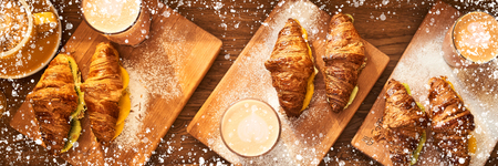 Web Banner 3 in 1 crop for design. Image with white powder desor frame. Fresh croissant and original authors coffee with fruits on table. Healthy breakfast food concept.の写真素材