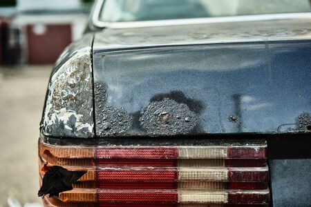 Details of old car. Aged oldtimer vintage automobile. Spare parts of retro classic automobile. Disassembled car in a parking lot.の写真素材