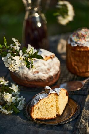 Traditional russian Easter cottage cheese dessert. Orthodox paskha, kulich cakes on table. Flowers bokeh background.の写真素材