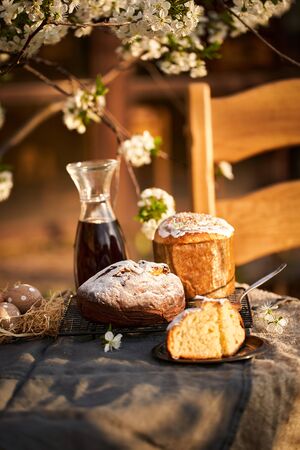 Traditional russian Easter cottage cheese dessert. Orthodox paskha, kulich cakes on table. Flowers bokeh background.の写真素材