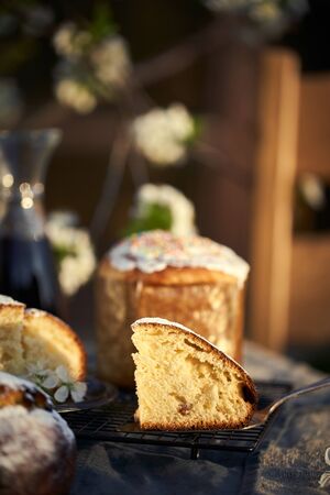 Traditional russian Easter cottage cheese dessert. Orthodox paskha, kulich cakes on table. Flowers bokeh background.の写真素材
