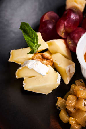 Cheese plate with camembert close up photoの写真素材