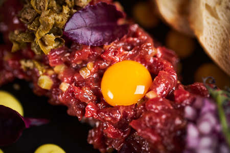 Close up macro view of tartare from beef with egg in restaurant.の写真素材