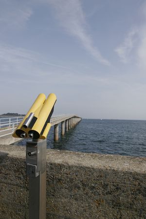 it is a view of the sea with a harbor and binocularsの写真素材