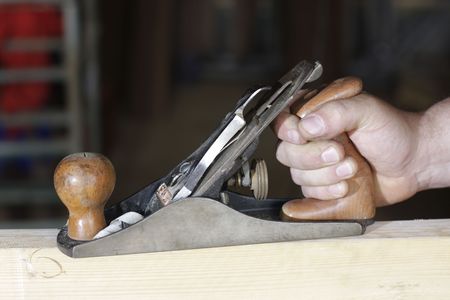 manual planer on a wood plank
