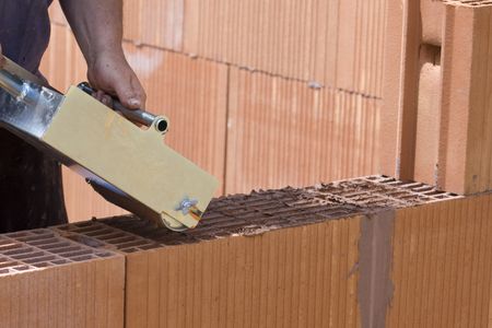 construction by red bricks with toolsの写真素材