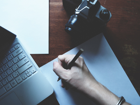 Work space with camera and laptopの写真素材