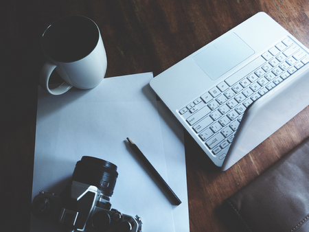 Work space with camera and laptopの写真素材
