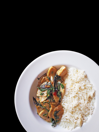 This is stir fried preserved pork sausage with Thai basil on black isolatedの写真素材