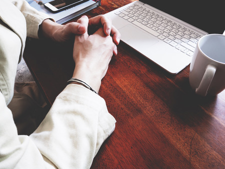 There are book, laptop, coffee cup, paper, and pencil on the office wooden  deskの写真素材