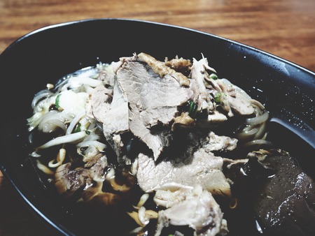 This is duck noodle in the  black bowl