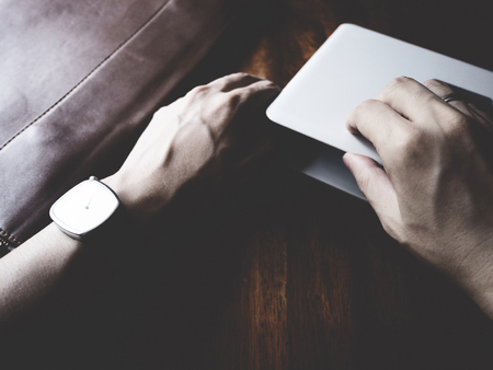 there are watch, laptop and leather bag on wooden table, minimal style,  soft toneの写真素材