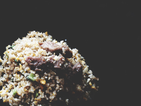 This is pork fried rice on black background, isolated,  soft toneの写真素材