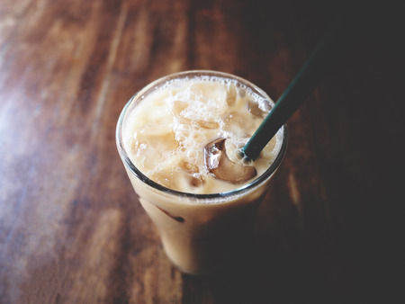 This is Thai iced tea in the glass above wooden desk,  soft toneの写真素材